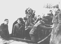 The crew reach land - Flt/Lt Freddy Green has his hands above his head in celebration